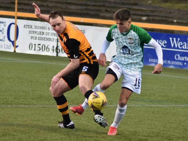 Jack Healy shields to ball from Alloa's Andy Graham