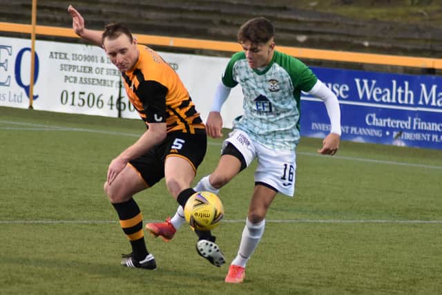 Jack Healy shields to ball from Alloa's Andy Graham