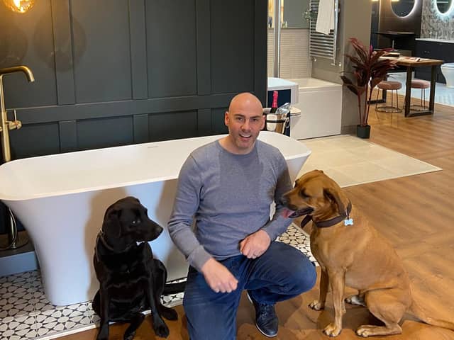 Sean Brown in his new showroom with his two dogs.