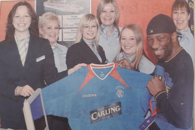 Former Raith Rovers star Marvin Andrews donated one of his signed Rangers strips to raise funds for Macmillan Cancer Relief.
He gave it to Thomson Travel Agency in the Mercat Shopping Centre, Kirkcaldy,  and is pictured handing it over to staff