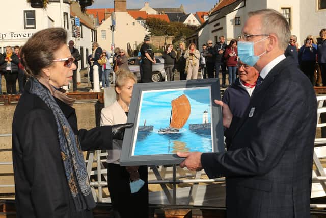 Princess Anne is presented with a painting of the Reaper by Arthur Nuttall