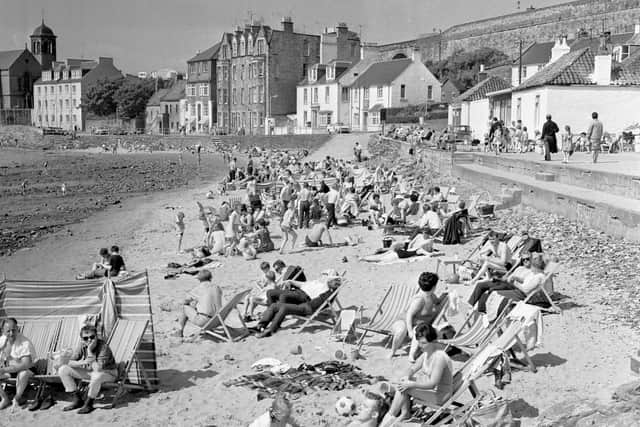 Past-times: A view of people enjoying the sunshine on the beach at Kinghorn in Fife