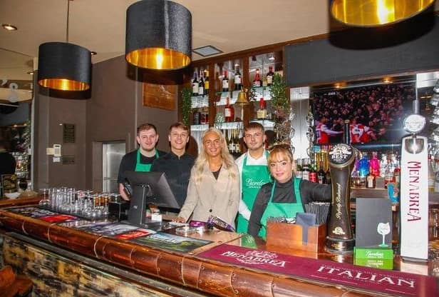 Licensee Lauren Hutchison (centre) with her staff at Alfie's in Kirkcaldy High St. Pic: Scott Louden.