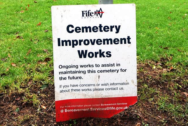 Fife Council sign in the cemetery where headstones have been placed on the ground because of an unsafe wall next to where they originally stood. Pic credit- Fife Photo Agency