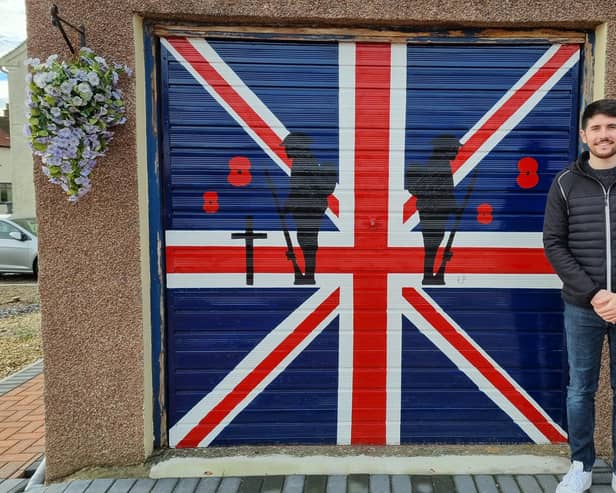 Kyle in front of his Remembrance Sunday garage door.