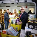 Pictured: Simon McMahon (Amazon) Gordon Brown, and  Pauline Buchan from the Cottage Family Centre at the warehouse which sits at the heart of the vast 'click and collect' project (Pic: Ian Georgeson)