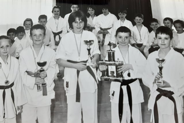 Trophy presentation time for youngsters who were members of Red Gate Karate in 1998. Pictured are Corrie McPherson, Sandy Henderson, Carol Smith, Kevin Brown and Marc Whyte. Picture from the Glenrothes Gazette archives.