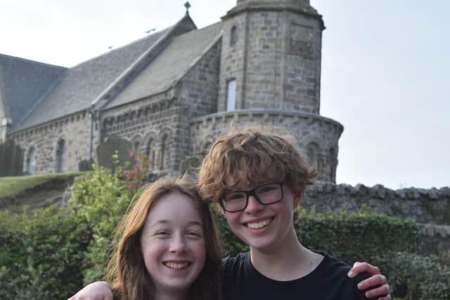 Lucy Smith and Ash Johnston at the end of their 43-mile trek outside St Athernase Church in Leuchars. (Photo: Paul Smith)