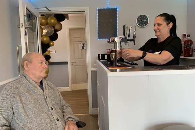 Wendy Parker pours a pint at the care home's newly opened bar (Pic: Submitted)