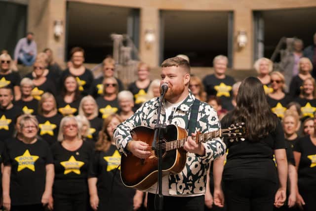 Cammy Barnes performs Bonnie's Song with Rock Choir on the steps of Glasgow's Royal Concert Hall.  (Pic: Luna Film Co)
