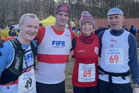 Fife AC runners Rory Sandilands and Stephen Dickson and Wizards Neill Mitchell and Karen Richards at the Falkland Playing Fields after representing their teams in the Devil's Burden relay race