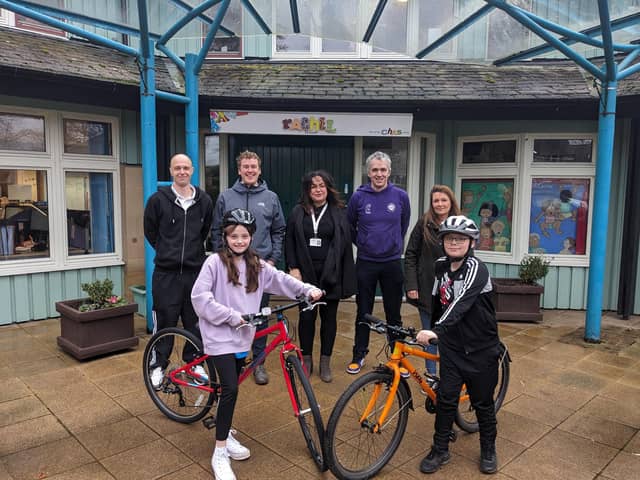 Alexa and Dylan with their new brand new bikes are pictured with Craig Mowbray (parent of Alexa), Ben Raw from Cycling Scotland, Leaghann Watson from CHAS, David Glover from Greener Kirkcaldy and Kirsty Gourlay (parent of Dylan).  (Pic: submitted)