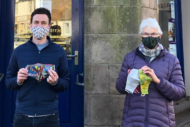Anne-Marijke Querido and Crail pharmacist Ian Rooney with some of her colourful face masks.