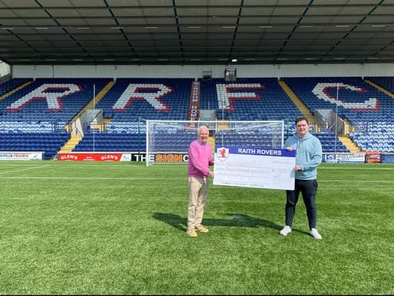 Martin Glass presents a cheque to Raith Rovers director Tom Morgan