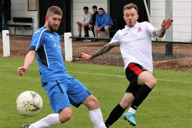 St Andrews United in action against Dalkeith Thistle in their last match of the 2021-22 season, with Ross Cunningham, right, making a challenge (picture by John Stevenson)