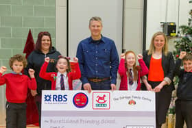 Collieson Briggs (centre)of Briggs Marine in Burntisland donating £10,000 to Burntisland Primary, CHAS and The Cottage Centre in  2016