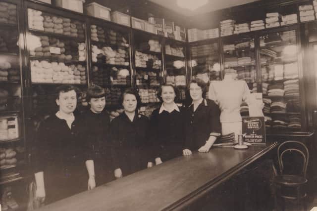 Shop assistants at work in this Dunfermline store, with its beautifully stacked jumpers and wool, back in the day when, as the sign on the counter advertises, you could have your hosiery repaired (date unknown). (Pic: ONFife)