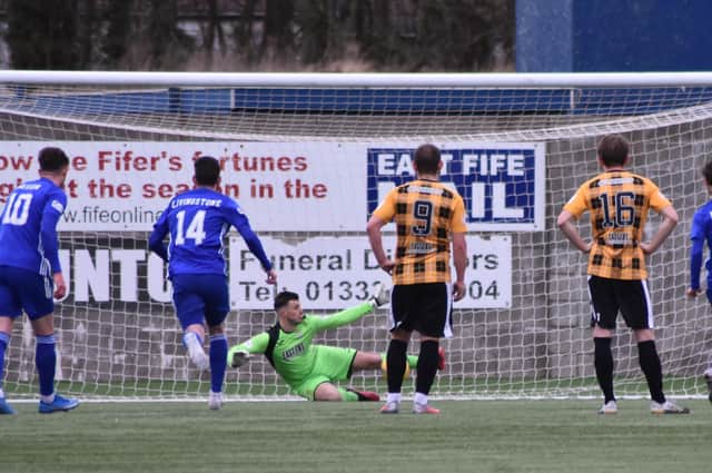 Brett Long gets a crucial block on Mitch Megginson's penalty. The goalie was then up quickly to beat away the rebound. Pic by Kenny Mackay.