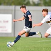 Ethan Ross prepares to unleash an effort with Dumbarton's Finlay Gray in pursuit (picture by Dave Johnston / Alba PIctures)