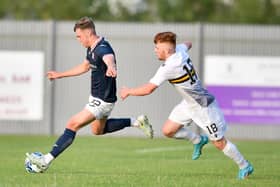 Ethan Ross prepares to unleash an effort with Dumbarton's Finlay Gray in pursuit (picture by Dave Johnston / Alba PIctures)