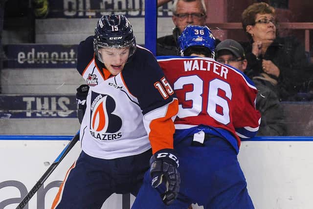 Collin Shirley #15 of the Kamloops Blazers  in action with Mitchell Walter of the Edmonton Oil Kings during a 2014 WHL game in Edmonton, Alberta, Canada. (Photo by Derek Leung/Getty Images)
