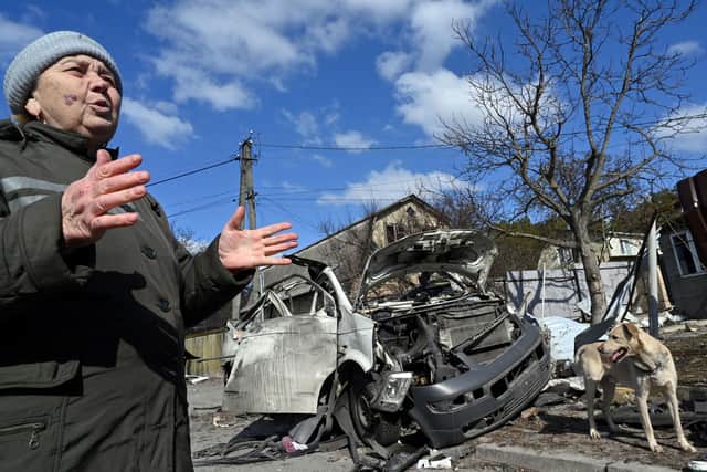 Nataliya Mykolaivna, 64, gestures as she talks to AFP journalist next to a minibus, bringing supplies and gifts to frontline soldiers volunteers and hard-pressed residents, destroyed by Russian shelling  (Photo by SERGEI SUPINSKY/AFP via Getty Images)