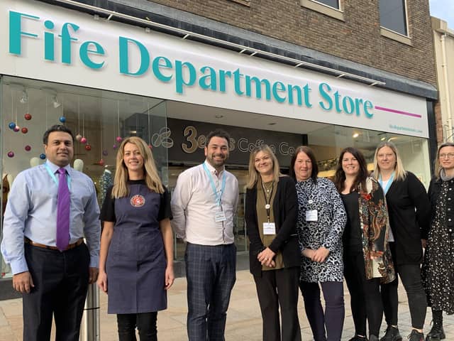 Tahir Ali, left, with staff from the new store at its launch in November 2021