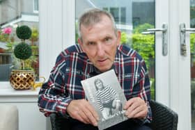 Former footballer Alan Miller, 76, with the book that he has written about his experiences. Pic: Michael Gillen