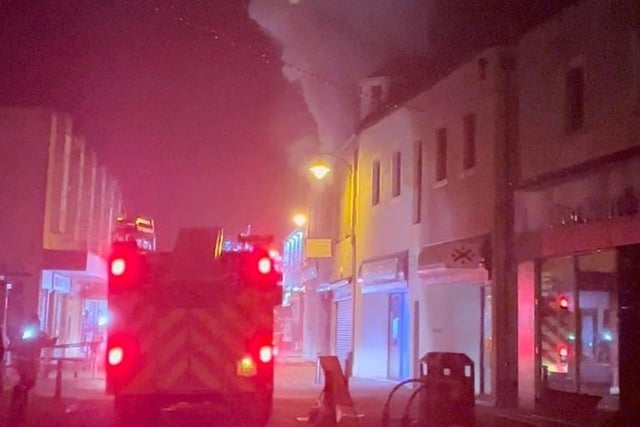 Thick smoke billows from the first floor of the building on fire in the heart of L:even town centre on Friday night.