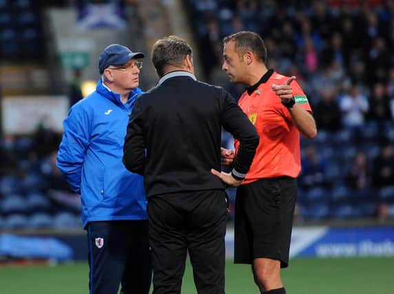 Referee Gavin Duncan speaks with John McGlynn (left) and Dunfermline manager Peter Grant (Pic: Fife Photo Agency)