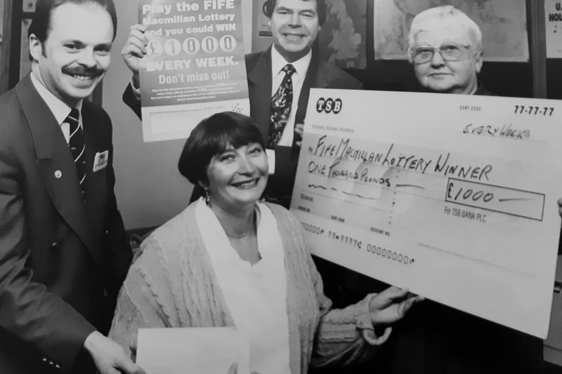 Presentation time for a lottery winner at AT Mays in Glenrothes. 
The winner, Marilyn Maule, is pictured with Alan Rankin of At Mays; Walter Barr from the Fife MacMillan Lottery, and Kathleen Budd, the agent who sold the winning ticket.
