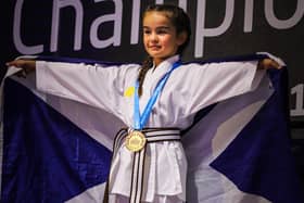 Jessica Brannan holds the saltire after becoming world karate champion