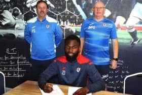 Blaise Riley-Snow puts pen to paper for Raith Rovers, with manager John McGlynn and assistant Paul Smith, left (picture by Tony Fimister/Raith Rovers)