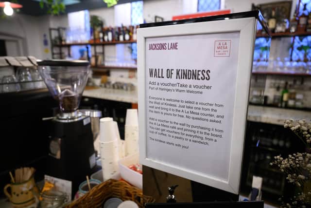 A "Wall of Kindness", where customers can pay it forward to provide others with a free warm drink or snack, is advertised in the "A La Mesa" coffee shop within Jacksons Lane theatre  in London (Photo by Leon Neal/Getty Images)