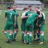 Jamie McNeish (yellow boots) is congratulated after fifth goal