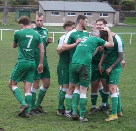 Jamie McNeish (yellow boots) is congratulated after fifth goal
