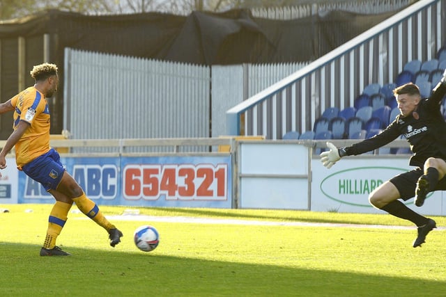 Mansfield's Nicky Maynard slots home the opening goal past Walsall's Liam Roberts in a 1-1 home draw in October 2020.