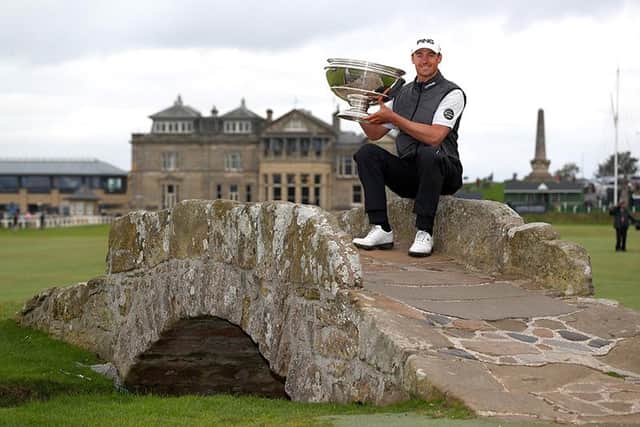 Victor Perez of France poses with the trophy on the Swilken Bridge at The Old Course in 2019. Photo by Matthew Lewis/Getty Images