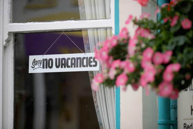 A 'No Vacancies' sign hangs in the window of a Bed and Breakfast guest house (Photo by Christopher Furlong/Getty Images)