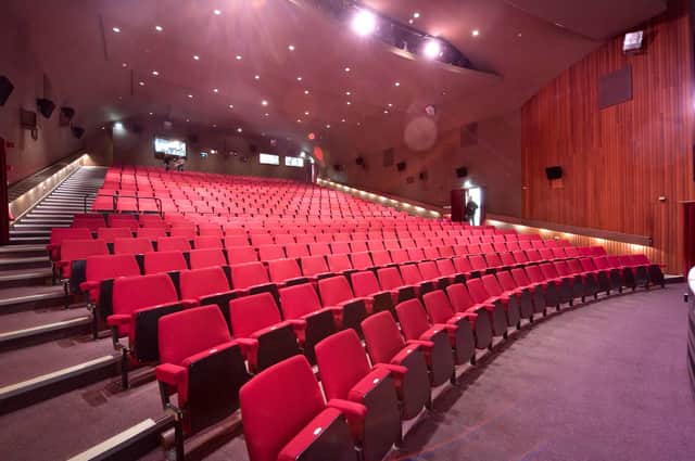 Five theatre chairs, saved from the Adam Smith Theatre before its renovation, are going up for auction.