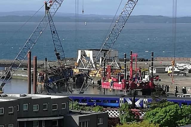 The crane upside down in the water after decommissioning efforts this morning.