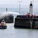 Hundreds turned out to line the harbour and welcome the lifeboat home on Sunday.  (Pic: Roger Grundy)
