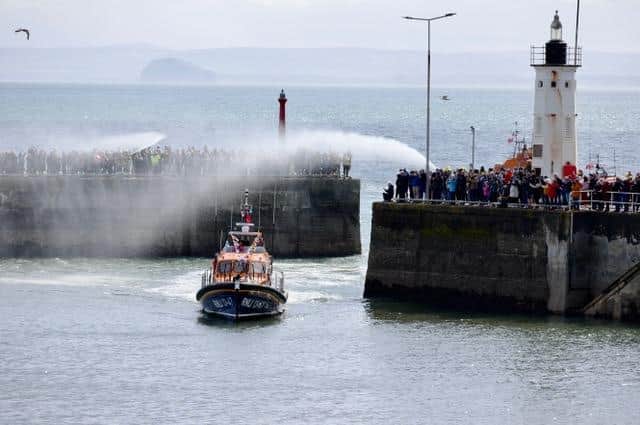 Hundreds turned out to line the harbour and welcome the lifeboat home on Sunday.  (Pic: Roger Grundy)