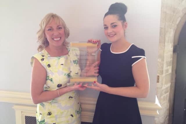 Bliss Beauty owner Christine Cunningham-Smith and assistant manager Charlene Londra with the Clarins Gold Award.