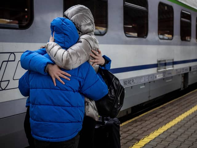 A family hugs each other to say good-bye at a railway station (Photo by WOJTEK RADWANSKI/AFP via Getty Images)