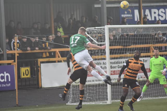 Aaron Steele wins this challenge in the air at the back post