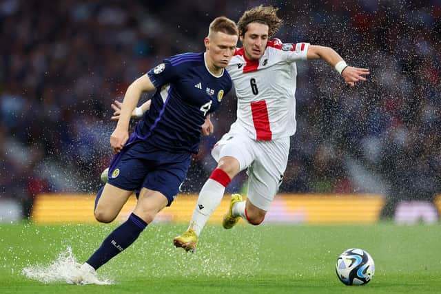 Scott McTominay of Scotland battles for possession with Luka Gagnidze of Georgia (Pic by Ian MacNicol/Getty Images)