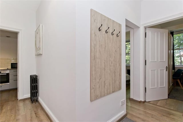 The entrance hall has two built-in storage cupboards and space for coats and shoes.