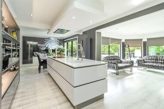 Kitchen with  floor to ceiling units, integrated appliances, and a stunning central island.
