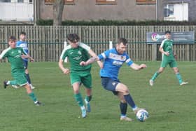 Tweedmouth Rangers' Ross Aitchison holds off Ciaran Healy of Thornton Hibs